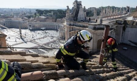 Workers installing a chimney pipe in the Sistine Chapel. Pic: Vatican Media/Reuters