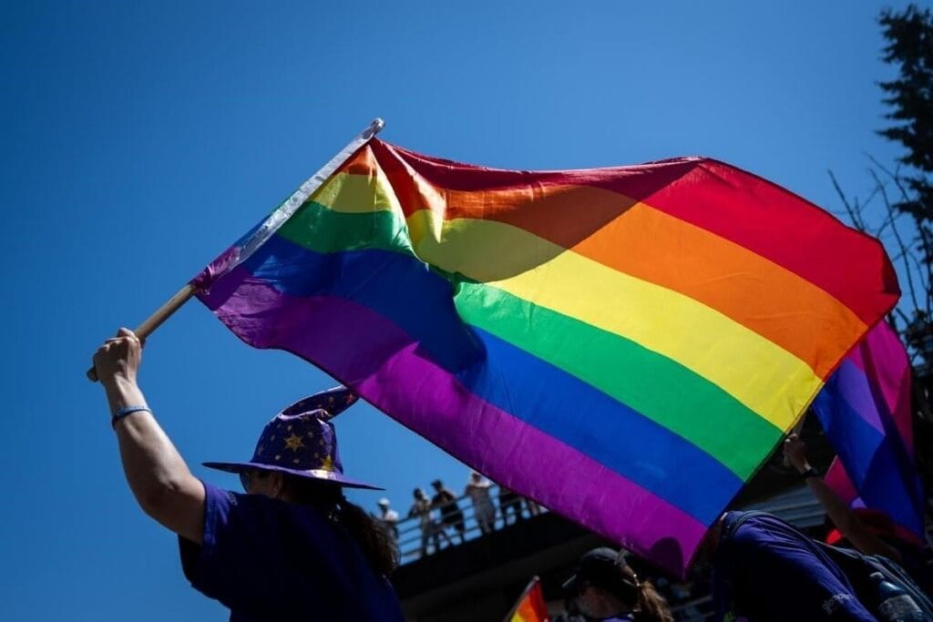A person walks with a Pride flag during the Pride Parade in Vancouver, B.C., Sunday, Aug. 4, 2024.  Ethan Cairns/The Canadian Press