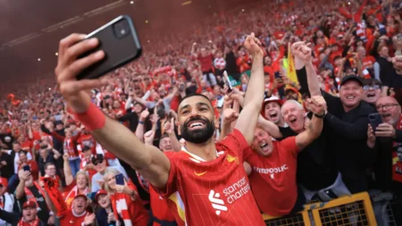 Liverpool players celebrate at Anfield after securing their 20th Premier League title with a 5 1 victory over Tottenham