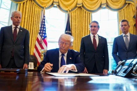 U.S. President Donald Trump signs an executive order, in the Oval Office, at the White House in Washington, D.C., U.S.