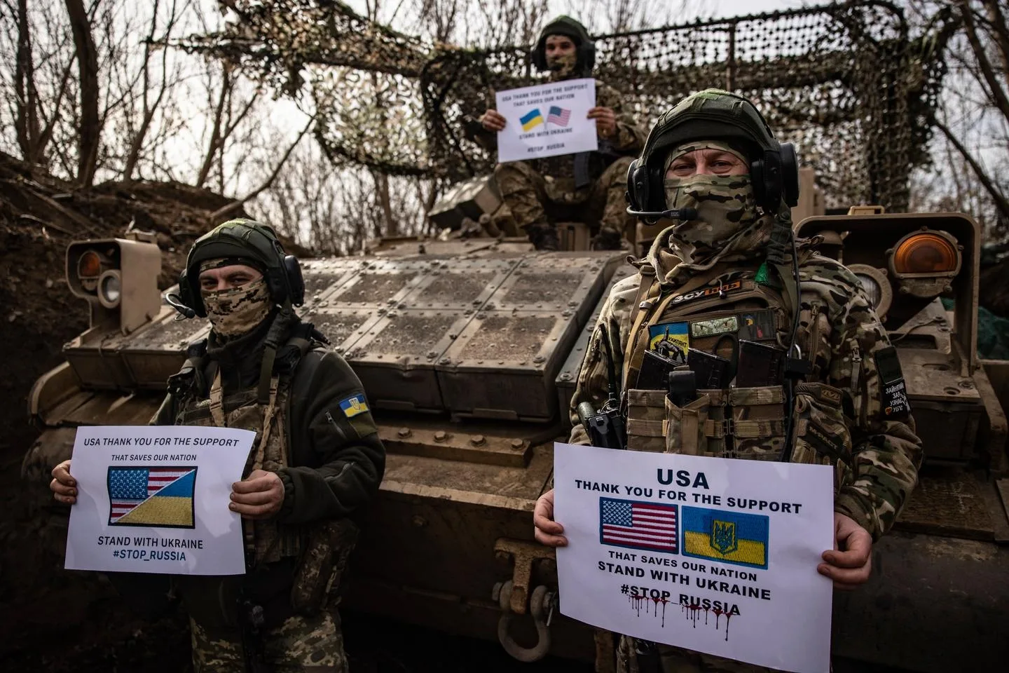 Soldiers of Ukraine's 100th mechanized brigade hold posters saying thanks to the US for support on the front line near Toretsk, Donetsk region, Ukraine, Monday, March 10, 2025. ROMAN CHOP / AP