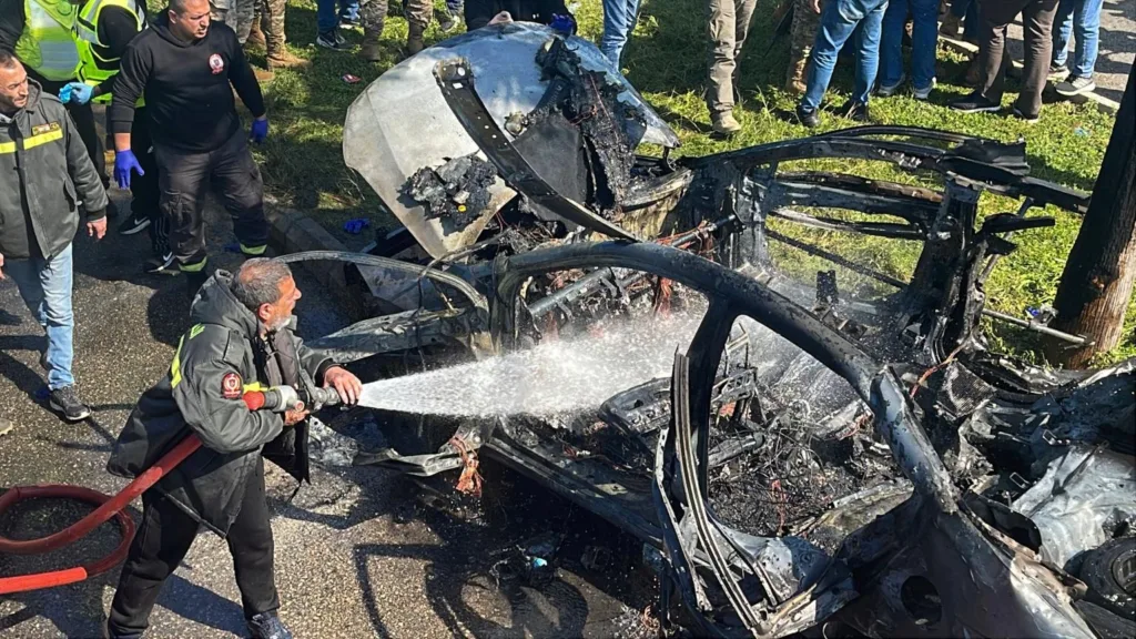 A Civil Defense firefighter hoses down a burned car that was hit by an Israeli drone strike, in the southern port city of Sidon, Lebanon, Monday, Feb. 17, 2025.AP