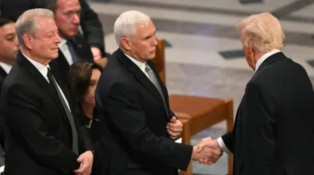 Former Vice President Al Gore watches as Mike Pence shakes hands with President-elect Trump at President Carter’s state funeral on Jan. 9, 2025.