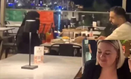 foreign women mocking a Muslim woman wearing a black veil X screengrab