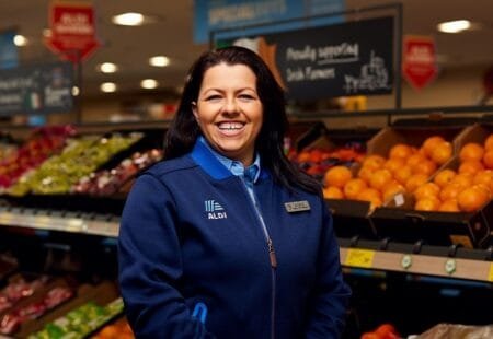 Aldi Ireland recruitment poster showing smiling staff in uniforms, with text promoting new job openings across Dublin and other counties.