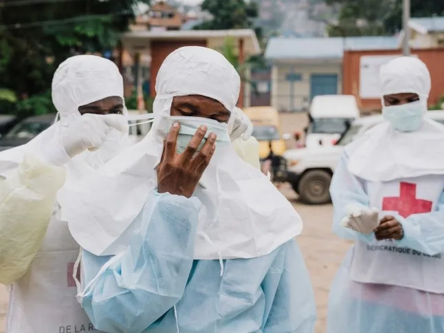 Congolese Red Cross staff don protective clothing before a mass burial (Picture: Hugh Kinsella Cunningham/Getty Images)