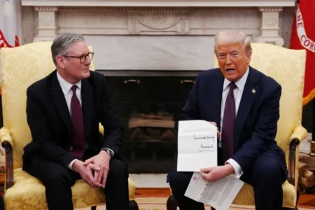 Donald Trump shows off his letter from the King (Picture: Reuters)