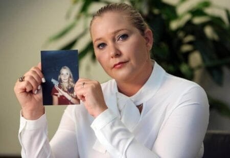 Virginia Roberts Giuffre, with a photo of herself as a teen, when she says she was abused by Jeffrey Epstein (Picture: TNS)