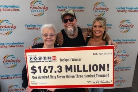 Powerball winner James Farthing (middle) posed with his girlfriend Jacqueline Fightmaster (right) and his mother Linda Grizzle (left) on Monday (Picture: Kentucky Lottery)
