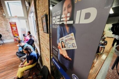 People wait inside a branch of the Louisiana Office of Motor Vehicles to receive a REAL ID (Picture: AP)
