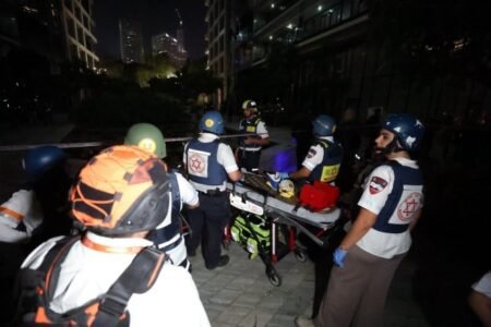Rescue and security personnel attend an evacuated building in Ramat Gan followinga missile attack from Iran (Picture: Reuters)