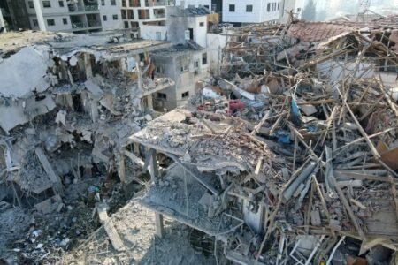 Damaged buildings at a site hit by a missile fired from Iran in the Israeli city of Ramat Gan (Picture: AFP)