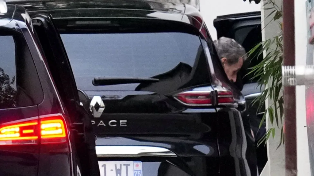 Nicolas Sarkozy steps out of his car at his Paris residence following his prison release. Image: AP.