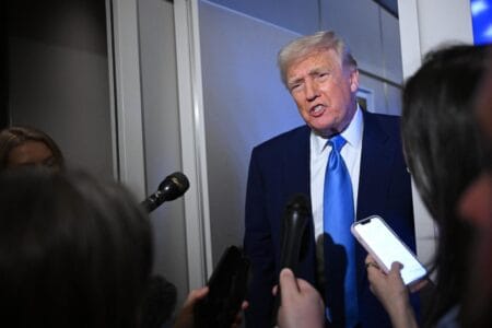 Trump speaks to reporters while in flight on Air Force One, en route to Joint Base Andrews on April 6, 2025.AFP via Getty Images
